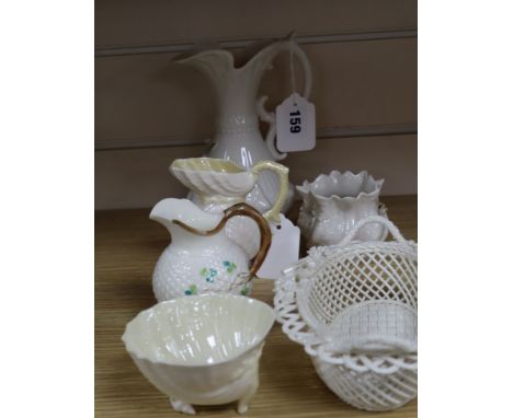 A Belleek 'Millennium' strawberry basket and five other items of Belleek, comprising a scroll-handled rose-encrusted pitcher,