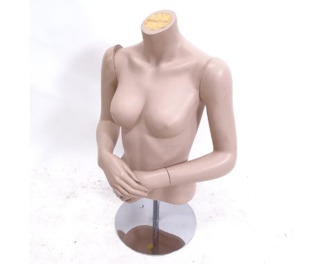 A half shop mannequin with articulated arms and wrists, on flat chrome base, H76cm 