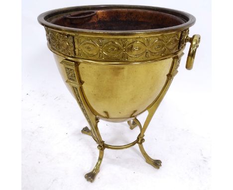 An embossed brass Adam style coal bucket, on claw feet, with ring handles, W36cm, H46cm 
