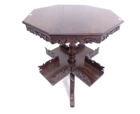 A Victorian carved oak book table, with octagonal top and rotating shelf below, on tripod base, W56cm, H63cm 