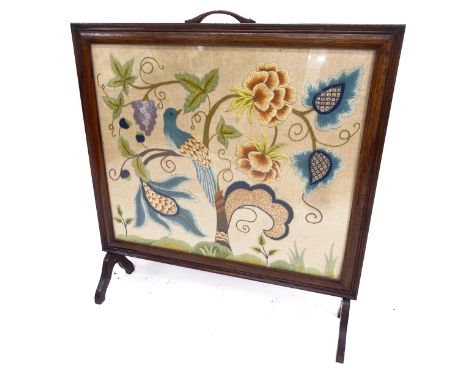 An Edwardian oak-framed fire screen, with and inset woolwork panel, W77cm, H82cm 