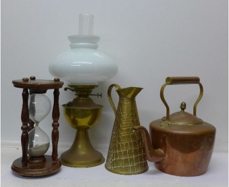 A copper kettle, an oil lamp, a hour glass and a brass jug