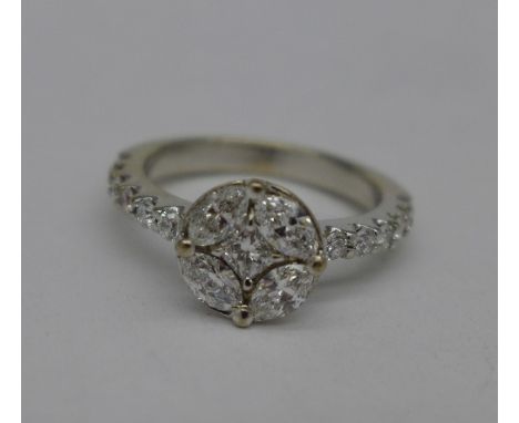 A white metal set diamond cluster ring, 4g, K, circa 0.75 carat diamond weight, (tests as 18ct gold)