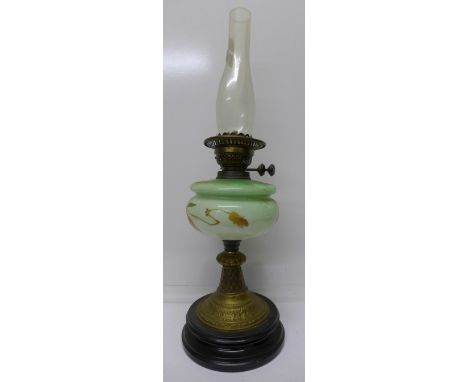 An oil lamp with painted opaque glass reservoir
