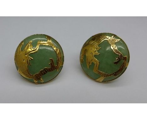 A pair of yellow metal mounted jade earrings