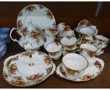 A Royal Albert Old Country Roses tea service comprising twelve cups, saucers and side plates, teapot, sugar, cream, vase, cak