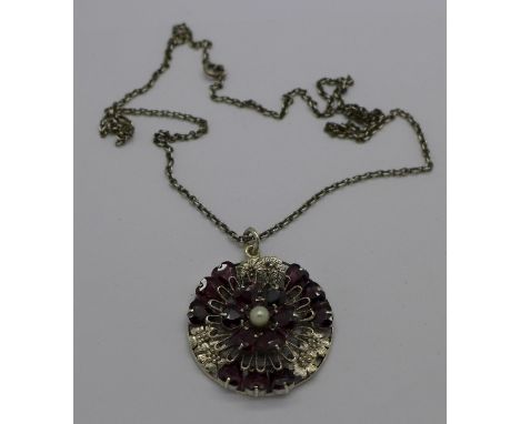 A silver, garnet and pearl pendant and chain