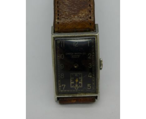 An Omega Watch Co., Tissot, wristwatch with black dial, hands loose