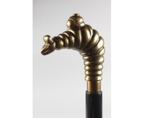 A WALKING STICK with MICHELIN MAN handle.