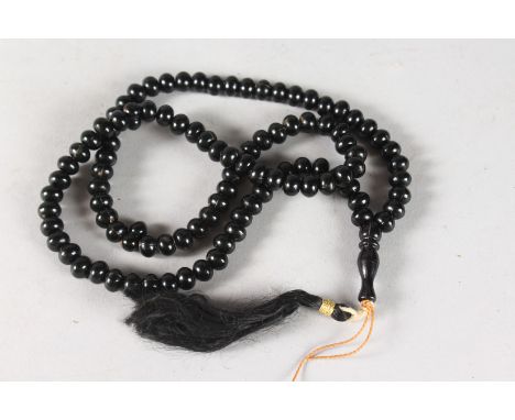 A GOOD SMALL JADE BEAD NECKLACE with tassel. 24ins long.