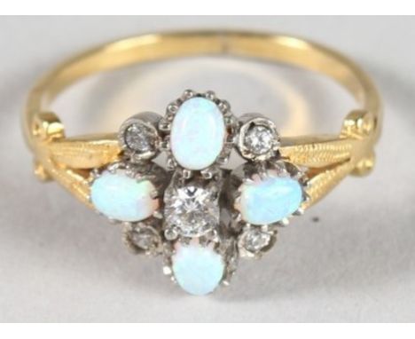 A SILVER AND GOLD FINISH OPAL CLUSTER RING.