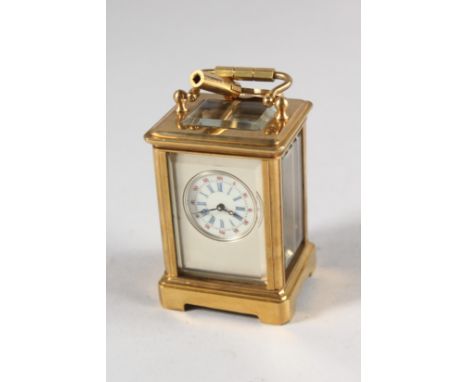 A GOOD MINIATURE SILVERED DIAL CARRIAGE CLOCK. 2.25ins high.