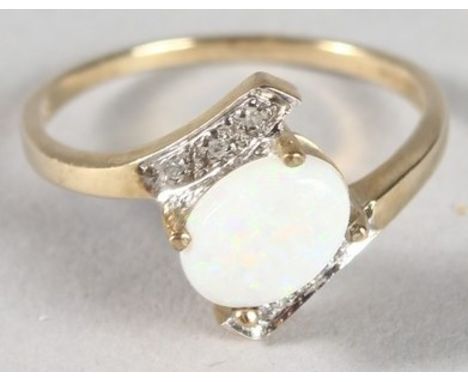 A 9CT GOLD OPAL AND DIAMOND RING.