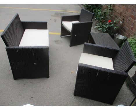 A brown finished wicker-style outdoor suite comprising a two seater sofa, two matching chairs and a glass topped coffee table