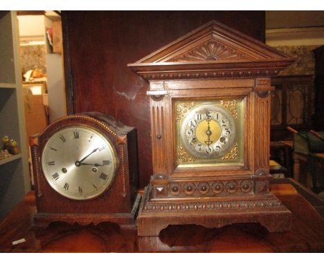 An oak cased Unghans mantel clock with a gong strike movement, brass and silvered dial, and a 1930s oak cased mantel clock Lo