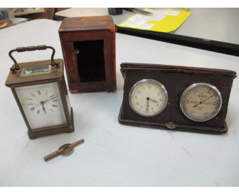 An early 20th century brass carriage clock with key and leather travel case together with a leather cased travelling clock an