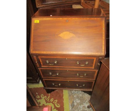 An Edwardian inlaid mahogany three drawer bureau with fitted pigeonhole interior with drawers, above one short, two long draw