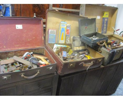A group of four vintage suitcases containing a mixed assortment of tools to include hammers, G-clamps, files and others 