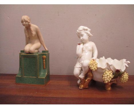 A Royal Worcester Art Deco Girl kneeling on a plinth and a Moore Brothers Cherub dish 