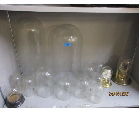 A selection of glass and plastic clock domes, a Hettich quartz anniversary clock, and one other together with clocks to inclu