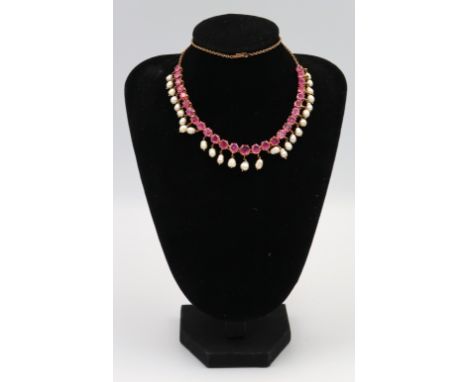 A ruby and freshwater pearl graduated fringe necklace. Length approx 470mm. Main necklace tests as high carat gold. Fittings 