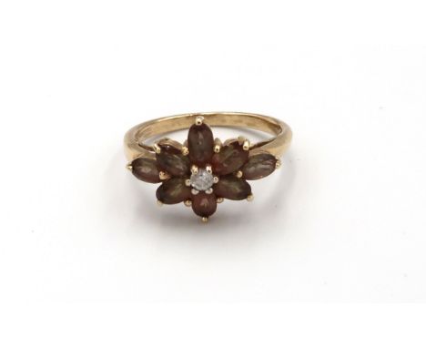 A 9ct gold smokey quartz flower ring. Size O1/2. Weight 3.13 grams. 