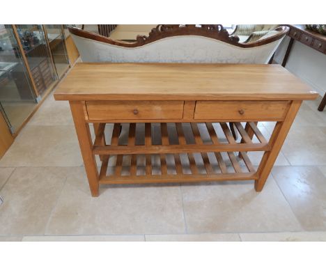 A light oak two tier kitchen table with two drawers raised on square supports - Width 140cm x Depth 45cm x Height 86cm 