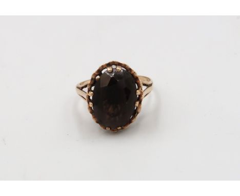 A 9ct gold smokey quartz single stone ring. Weight 3.26 grams. Size O. 