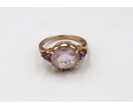 A 9ct gold pink gem and amethyst dress ring. Size N. Weight 3.12 grams. 