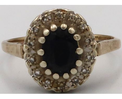 A 9ct Yellow Gold Diamond and Sapphire cluster ring. Size P/Q 2grams. 