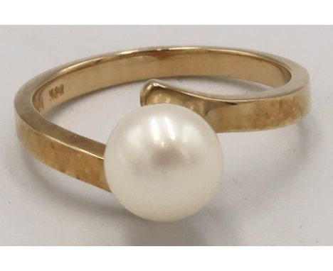 A 6.8mm cultured pearl dress ring. Stamped 10K. Size J. Weight 2.5 grams. 