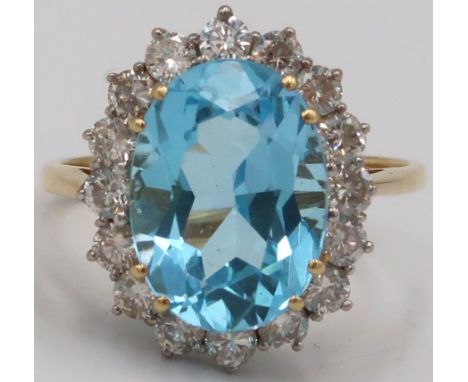 An 18ct Yellow gold blue topaz and diamond cluster ring. Size Q/R 4.0 grams 