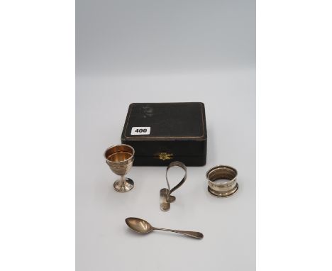 A silver H.M. Christening set including pusher, egg cup, napkin ring and spoon. 2 troy oz. 