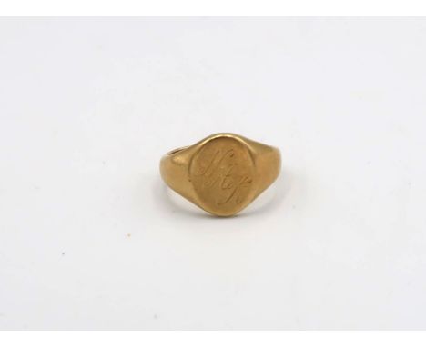 An 18ct yellow gold signet ring, approx 6.89 grams. Size K. Engraved with the initials NHK 