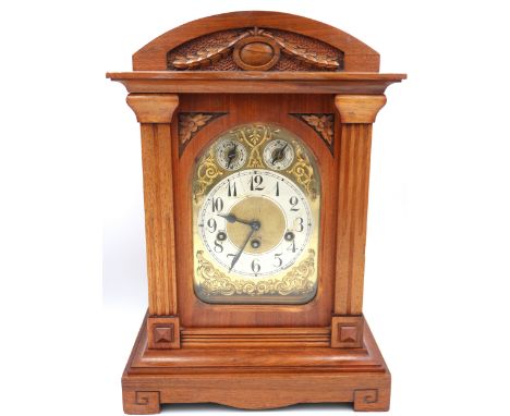 A mahogany cased mantle clock, gilt face with Arabic numerals to silvered chapter ring, subsidiary dials at 10 and 2 o'clock.