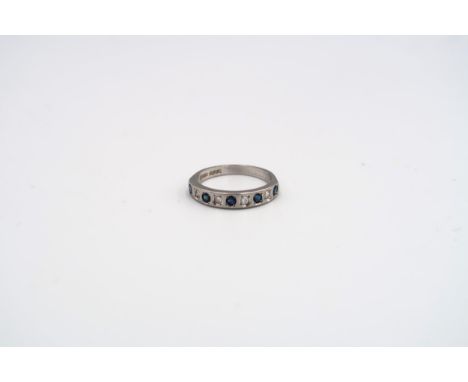 A silver diamond and sapphire dress ring set with nine stones - ring size N 