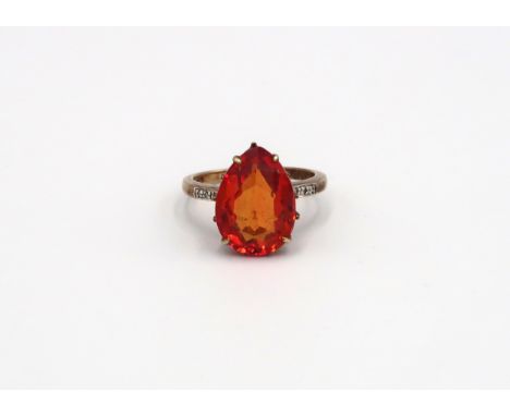 A 9ct Yellow Gold Dress ring with large tear shaped red gemstone to shoulder. Size R - approx weight 5.4 grams. 
