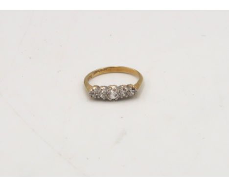 A cubic zirconia five stone ring. Stamped 18ct. Size I. Weight 2.06 grams. 