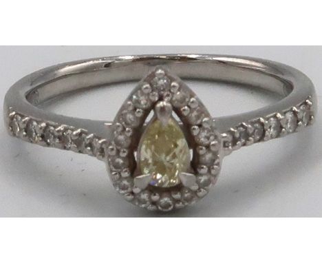 A platinum pear shape diamond cluster ring. The central yellow pear shape diamond estimated 0.19ct, untested for natural colo