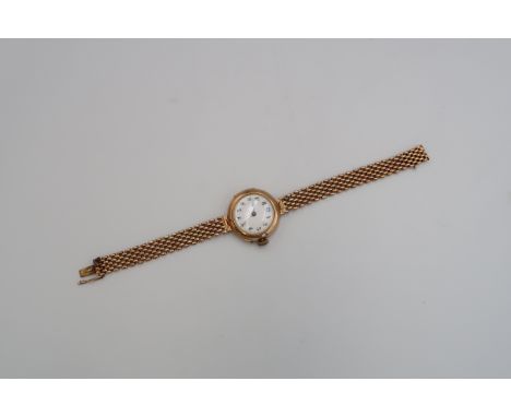 A 9ct rose gold cased ladies watch, arabic numerals to white enamel dial, approx 23.5 grams 