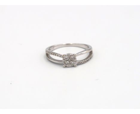 An 18ct white gold designer diamond cluster ring with diamond shoulders, head size approx 20mm x 6mm, Size N 
