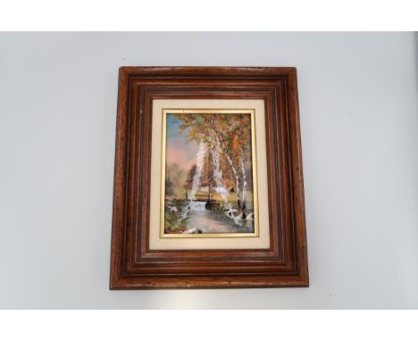 A Limoges enamel plaque in frame, River scene with dwelling beyond. 15cm x 10cm 