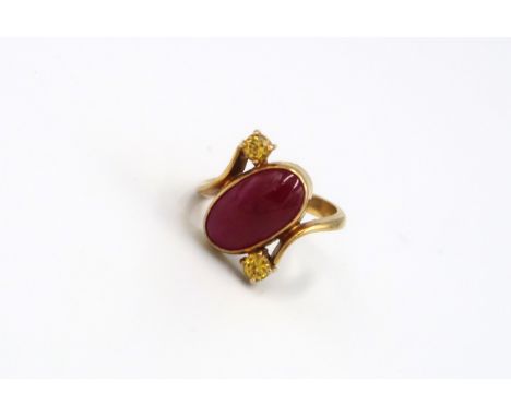 A 9ct Yellow Gold Dress ring with Oval cut red gemstone to shoulder Size R - approx weight 6.3 grams 