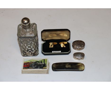 A box containing white metal mounted scent bottle; a horn comb; cigarette cards; a pair of rolled gold cuff-links and two sil