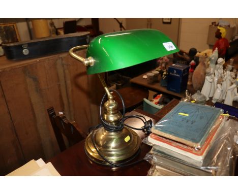 A brass desk lamp with green glass shade 