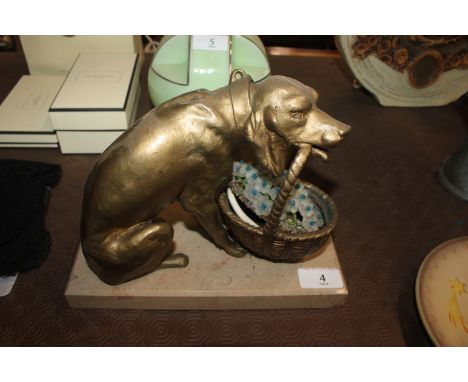 An Art Deco design table lamp in the form of a gilded dog carrying a basket of flowers on marble plinth