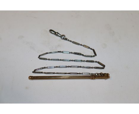 A 9ct gold propelling swizzle stick with white metal chain