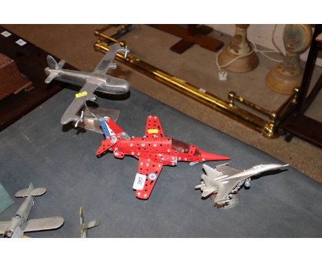 A Meccano model "Red Arrow"; a chrome model plane on stand and one other of a Mig 29
