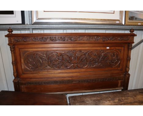 A continental carved walnut bedhead or overmantel with profuse foliate decoration, approx. 180cm wide x 130cm high 