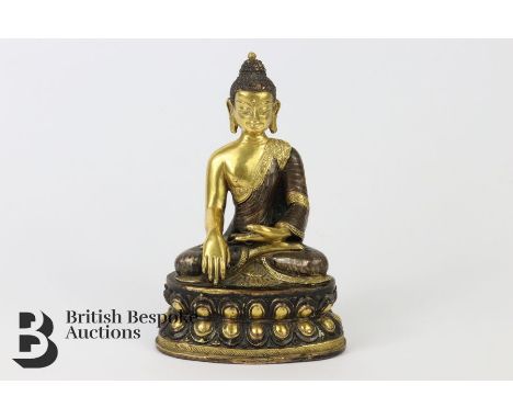 A gilt-bronze buddha Chinese or Tibetan, depicted seated in dhyanasana, his left hand resting upon his lap in dhyana and ligh